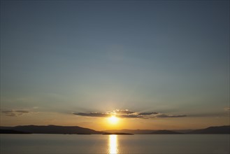 USA, Montana, Flathead Lake, View of sunset over lake. Photo: Noah Clayton