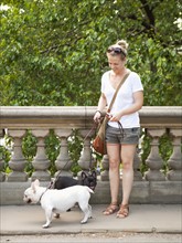 Young woman with dogs on walk. Photo : Jessica Peterson