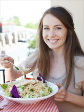 Portrait of young woman having salad. Photo : Jessica Peterson