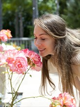 Young woman smelling rose. Photo: Jessica Peterson