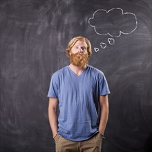 Man in front of blackboard with drawing depicting speech bubble. Photo: Jessica Peterson