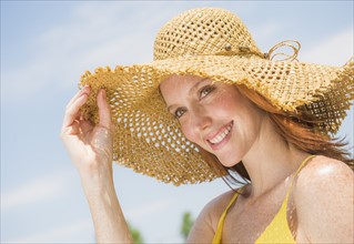 Portrait of woman wearing straw hat. Photo : Tetra Images