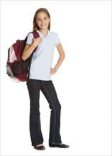 Portrait of schoolgirl (10-11) with backpack, studio shot.