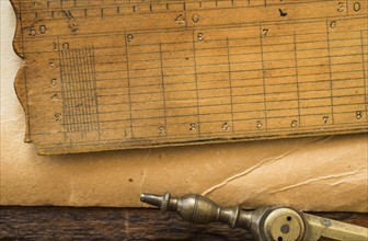 Old brown paper with ruler and compass, studio shot.