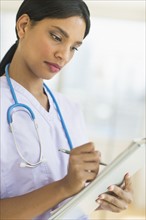 Female doctor holding clipboard.