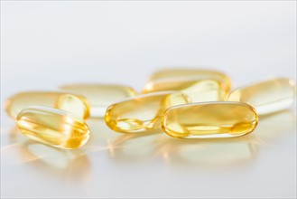 Omega fatty acid pills on white background, studio shot.