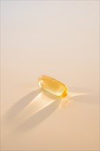 Omega fatty acid pill on white background, studio shot.