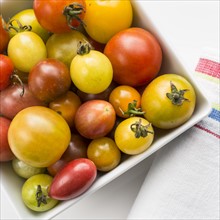 Heirloom tomatoes in plate, studio shot.