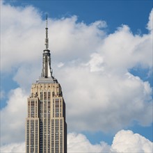 Empire State Building under blue sky.