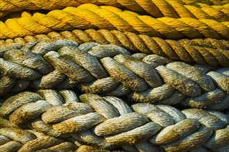 Braided ropes in harbor, close-up.