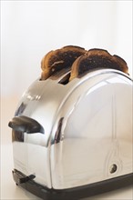 Burnt toasts in toaster.