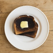 Burnt toasts on plate.