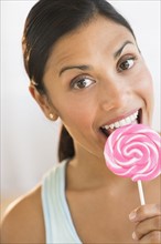 Woman eating lollypop.