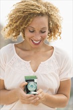 Young woman holding camera.