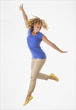 Woman jumping, studio shot.