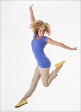 Woman jumping, studio shot.