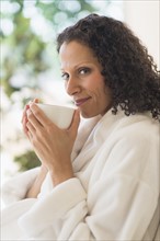 Woman relaxing with cup of coffee.