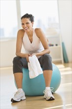 Portrait of woman sitting on exercise ball.