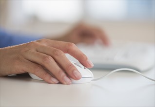 Human hand with computer mouse.