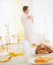 Woman in white robe drinking tea. Photo: Daniel Grill