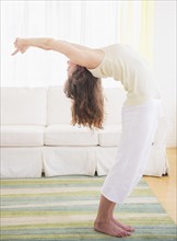 Young woman exercising at home. Photo: Daniel Grill