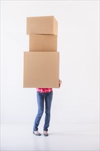 Studio shot of young woman carrying stack of boxes. Photo: Daniel Grill