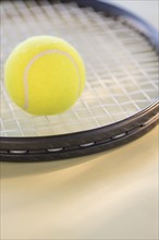 Studio Shot of tennis racket with ball. Photo : Daniel Grill