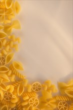Variety of yellow pasta with blank white space in upper right corner. Photo: Daniel Grill