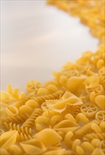 Variety of yellow pasta with blank white space in upper left corner. Photo: Daniel Grill
