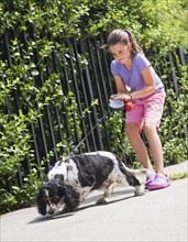 Girl (8-9) walking her dog . Photo: Daniel Grill