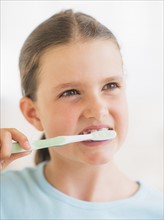Young girl brushing her teeth. Photo: Daniel Grill