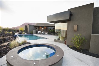 Modern luxury home facing swimming pool.