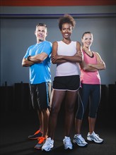 Portrait of three people in gym.