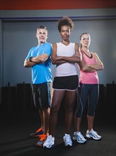 Portrait of three people in gym.