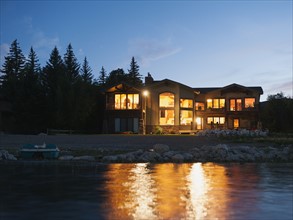 evening view of holiday villa from lake. Photo: Erik Isakson