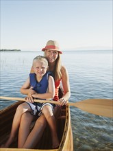 Portrait of young woman with son (4-5) canoe traveling.