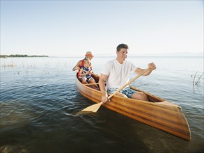 Family with son (4-5) canoe traveling.