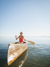 Portrait of young woman canoe traveling.
