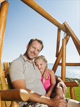 Portrait of father with daughter (4-5) on swing. Photo: Erik Isakson