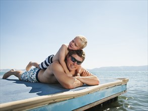 Father with son sunbathing. Photo: Erik Isakson