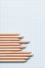 Grouping of wooden pencils in graph shape on graph paper. Photo : Kristin Duvall