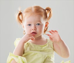 Studio shot of Beautiful Redhead toddler girl looking at camera. Photo: Mike Kemp