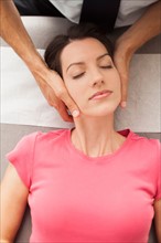 Woman laying down getting neck adjusted by chiropractor. Photo : Mike Kemp