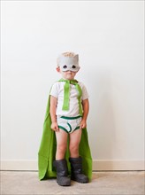 Studio shot, Portrait of boy (2-5 years) wearing green cape and mask. Photo: Jessica Peterson