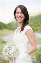 Portrait of smiling woman in white dress. Photo : Jessica Peterson