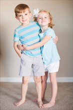 Portrait of hugging siblings. Photo : Jessica Peterson