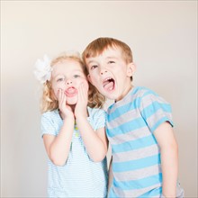 Studio Shot, Portrait of girl and boy making faces. Photo : Jessica Peterson