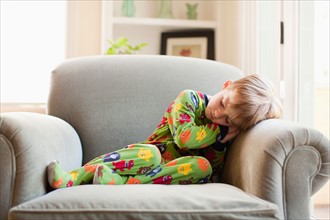 Boy in his pijamas sleeping on armchair. Photo : Jessica Peterson
