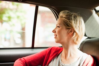 Portrait of woman on back seat of car. Photo : Jessica Peterson