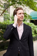 Portrait of elegant man talking on phone. Photo : Jessica Peterson